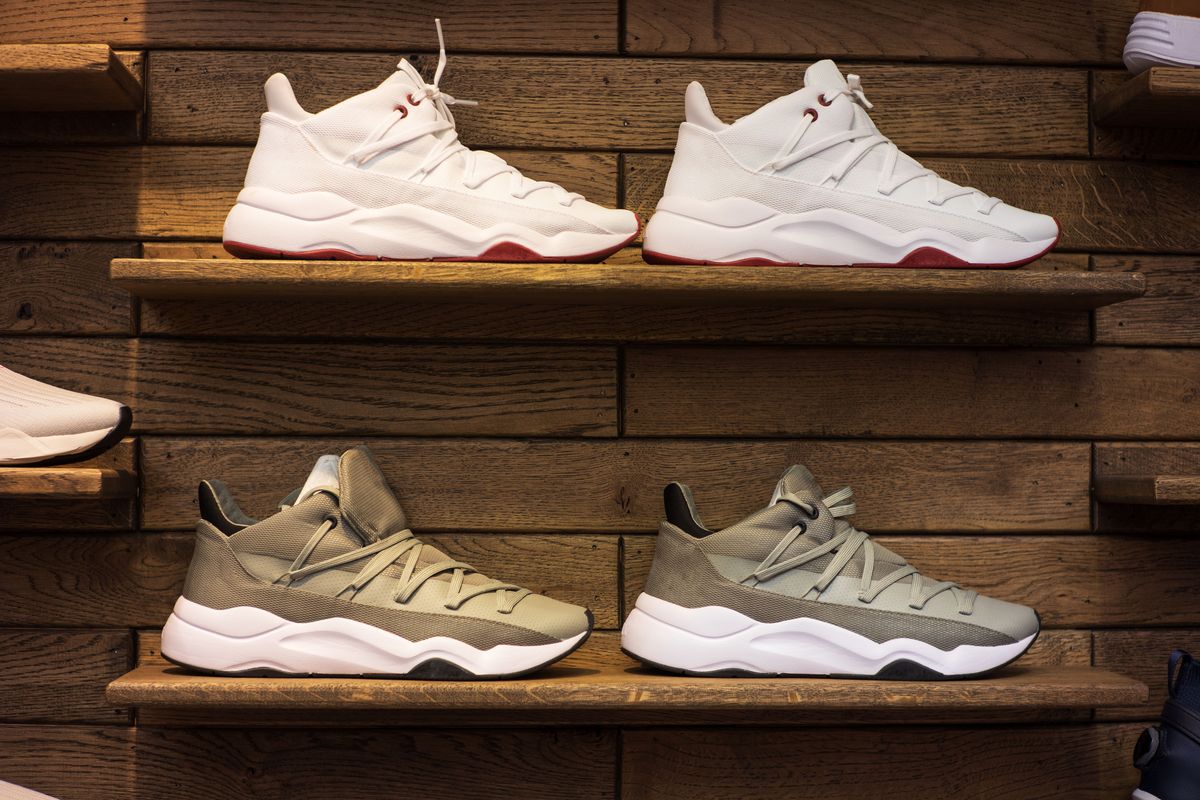Shoe store display with shoes on wooden shelves