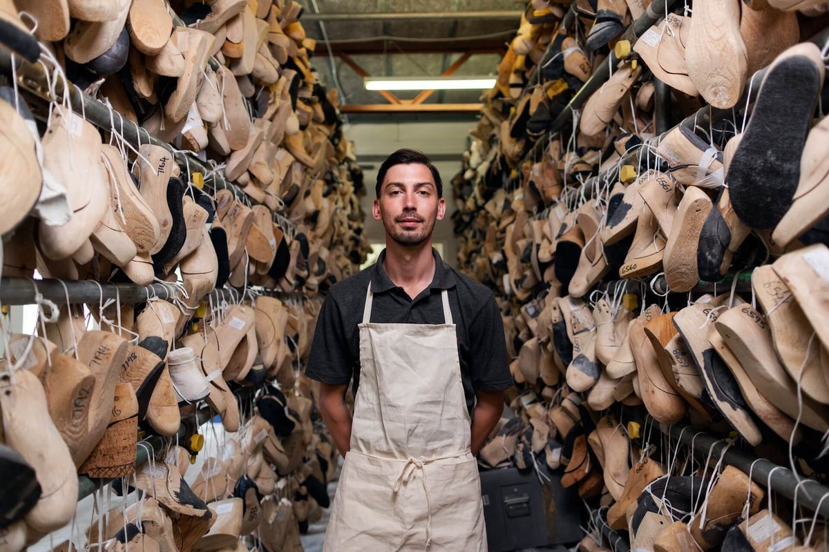 Shoe samples with custom branded insoles and printed boxes on a workbench at the Nylex Shoes factory in Port Louis